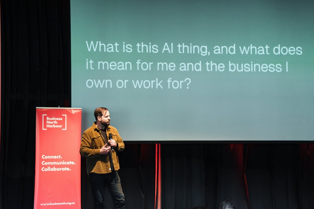 An iT360 presenter leading an AI workshop on stage